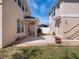 Spacious backyard with tiled patio, a small patch of grass, and a privacy fence at 6475 New Independence Pkwy, Winter Garden, FL 34787