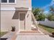Exterior door with staircase and brick pavers surrounded by landscaping and rocks at 6475 New Independence Pkwy, Winter Garden, FL 34787