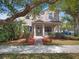 Charming two-story home features a well-manicured lawn, inviting front porch, and elegant architectural details at 6475 New Independence Pkwy, Winter Garden, FL 34787