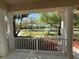 Scenic view from the covered porch overlooking a tranquil neighborhood pond at 6475 New Independence Pkwy, Winter Garden, FL 34787