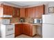 Well-lit kitchen features ample wood cabinetry, a white range, and stainless steel microwave at 6475 New Independence Pkwy, Winter Garden, FL 34787