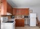 Well-lit kitchen features ample wood cabinetry, a white range, and stainless steel microwave at 6475 New Independence Pkwy, Winter Garden, FL 34787