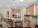 Eat-in kitchen featuring seating at the bar, stainless steel appliances and warm-toned cabinets at 6475 New Independence Pkwy, Winter Garden, FL 34787