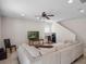 Comfortable living room offers neutral paint, ceiling fan, and tile floors at 6475 New Independence Pkwy, Winter Garden, FL 34787