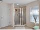 Walk-in shower featuring glass doors and tile surround at 6475 New Independence Pkwy, Winter Garden, FL 34787