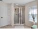 Walk-in shower featuring glass doors and tile surround at 6475 New Independence Pkwy, Winter Garden, FL 34787