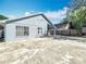 Rear view of the house with a large concrete backyard and privacy fence at 6921 Blair Dr, Orlando, FL 32818