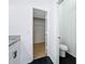Bathroom with toilet and walk-in closet featuring hardwood flooring and ample storage space at 6921 Blair Dr, Orlando, FL 32818