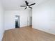 Large bedroom with vaulted ceiling, wood-look floors and an ensuite bathroom offers comfort and style at 6921 Blair Dr, Orlando, FL 32818