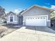 Well-kept single-story home with a two-car garage, attractive curb appeal, and a freshly sealed concrete driveway at 6921 Blair Dr, Orlando, FL 32818