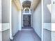 Inviting front entrance featuring a security gate and classic architectural details, enhancing the home's appeal at 6921 Blair Dr, Orlando, FL 32818