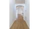 Bright hallway with new wood-like floors and an arched entryway, leading to the main living areas of the home at 6921 Blair Dr, Orlando, FL 32818
