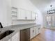 Bright kitchen with white cabinets, granite countertops, stainless steel appliances and hardwood floors is move-in ready at 6921 Blair Dr, Orlando, FL 32818