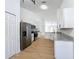 Spacious kitchen features stainless steel appliances, granite countertops, and white cabinetry with wood-look floors at 6921 Blair Dr, Orlando, FL 32818