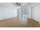 Bright living room with wood floors and a sliding glass door to the outside at 6921 Blair Dr, Orlando, FL 32818