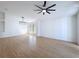 Sun-filled living room with modern light fixture and wood floors at 6921 Blair Dr, Orlando, FL 32818