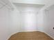 Walk-in closet featuring hardwood floors, wire shelving, and ample storage space at 6921 Blair Dr, Orlando, FL 32818