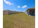 Spacious backyard with a view of neighboring houses and blue skies at 992 Serchio St, Haines City, FL 33844