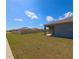 Wide angle view of the backyard and covered patio area with fence at 992 Serchio St, Haines City, FL 33844