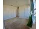 Spacious carpeted bedroom with a window and green curtains for lots of natural light at 992 Serchio St, Haines City, FL 33844