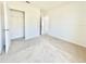 A bright, carpeted bedroom features neutral walls, a closet, and an open doorway at 992 Serchio St, Haines City, FL 33844