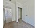 Bedroom with neutral carpet and a closet, next to a tiled room at 992 Serchio St, Haines City, FL 33844