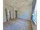 Bright bedroom with carpet, closet, and large window with light-filtering curtains at 992 Serchio St, Haines City, FL 33844
