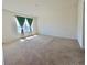 Spacious bedroom with plush carpet, large window, and bright natural light at 992 Serchio St, Haines City, FL 33844