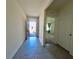 Inviting entryway with tile flooring, offers a view of a carpeted bedroom enhancing the home's layout and design at 992 Serchio St, Haines City, FL 33844