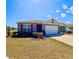 Inviting single-Gathering home with a two-car garage, vibrant red shutters, and a lush green lawn at 992 Serchio St, Haines City, FL 33844