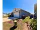 Side angle of home featuring garage, nice landscaping and trash cans at 992 Serchio St, Haines City, FL 33844