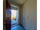 Inviting entryway with an open front door and tile flooring, leading to a bright and airy interior at 992 Serchio St, Haines City, FL 33844