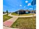 Single-Gathering home featuring a well-maintained lawn and landscaping in a suburban setting, showcasing curb appeal at 992 Serchio St, Haines City, FL 33844