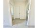 Tile hallway with white walls and doors on either side of the passageway at 992 Serchio St, Haines City, FL 33844
