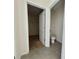 Hallway with access to closet with shelving and bathroom with toilet at 992 Serchio St, Haines City, FL 33844