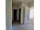 Hallway view with tile flooring showing access to a bathroom and carpeted room at 992 Serchio St, Haines City, FL 33844