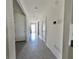 Long hallway with tiled floors, white walls and multiple access doors at 992 Serchio St, Haines City, FL 33844