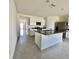 Bright kitchen with granite countertops, stainless steel appliances, and white cabinetry at 992 Serchio St, Haines City, FL 33844