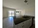 Modern kitchen island featuring granite countertops and a stainless steel sink at 992 Serchio St, Haines City, FL 33844
