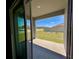 View from the sliding glass doors to the covered patio and green backyard at 992 Serchio St, Haines City, FL 33844