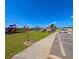 Community playground and pool area, featuring colorful equipment, parking and tropical palm trees at 992 Serchio St, Haines City, FL 33844