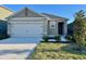 Inviting single-story home featuring a two-car garage and a well-manicured front yard at 994 King Parc Rd, Orange City, FL 32763