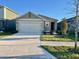Well-maintained single-story home featuring a two-car garage and a neat front lawn at 994 King Parc Rd, Orange City, FL 32763