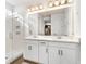 Bathroom featuring double vanity with bright mirror, a glass shower, and access to the walk-in closet at 10372 Austrina Oak Loop, Winter Garden, FL 34787