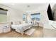 Bright bedroom featuring wood floors, a work station by the window, and a television mounted on the wall at 10372 Austrina Oak Loop, Winter Garden, FL 34787