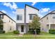 Striking modern two-story home with stone accents, landscaping, and contemporary design at 10372 Austrina Oak Loop, Winter Garden, FL 34787