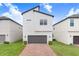 Modern two-story home with brick driveway, gray garage door, and well-maintained landscaping at 10372 Austrina Oak Loop, Winter Garden, FL 34787