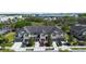 Exterior aerial view of townhomes featuring individual driveways and attached garages at 10785 Corsican St # 3, Orlando, FL 32824