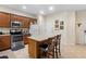 Well-equipped kitchen featuring stainless steel appliances, a center island, and classic brown cabinetry at 10785 Corsican St # 3, Orlando, FL 32824