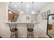 Open kitchen featuring bar seating, granite countertops, and views to other rooms at 10785 Corsican St # 3, Orlando, FL 32824
